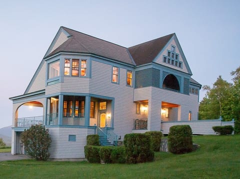 View of the house lit up in the evening.