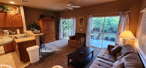 Spacious living area with comfortable seating, large windows, and access to the private screened patio.