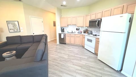 Open kitchen and living space with full-size appliances, breakfast bar seating, and a comfortable layout.