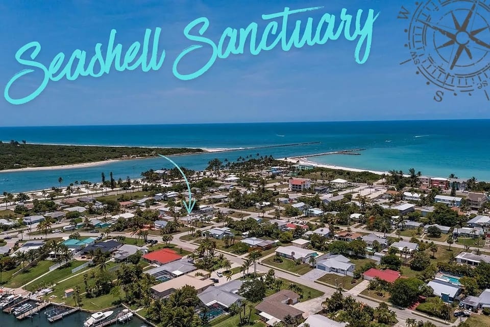 Aerial view of Seashell Sanctuary near the water, highlighting the coastal location and surrounding neighborhood.