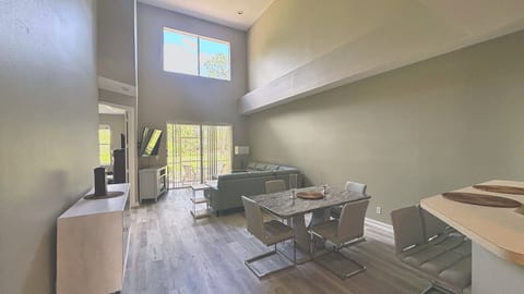 Welcome to a bright and expansive living space! This dramatic, two-story great room features beautiful wood-look flooring, neutral tones, and an open layout that effortlessly connects dining and lounging areas.