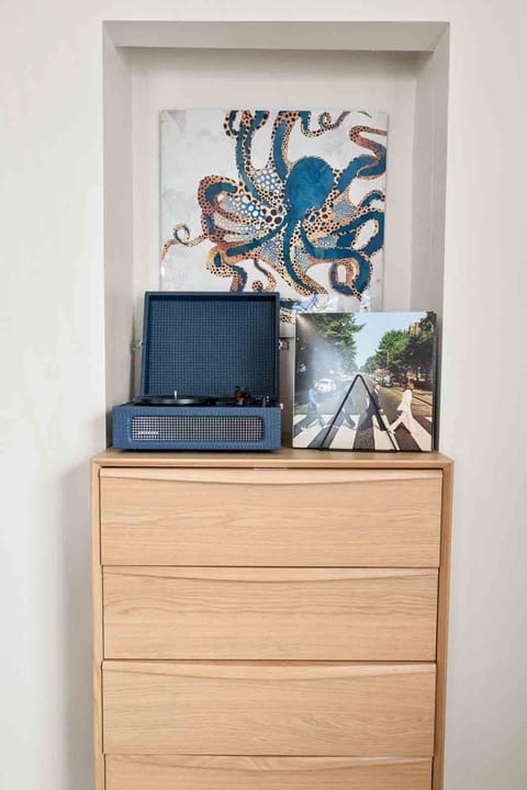 Set the perfect vibe with our Bluetooth-enabled record player, complete with a curated collection of classic and modern vinyl records. Whether you want to stream your own playlist or spin a timeless album, this setup adds a nostalgic touch to your stay.