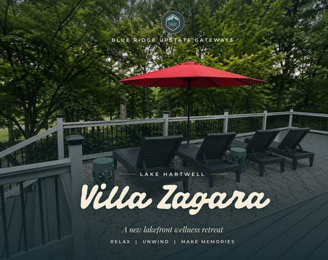 Private wooded deck with lounge chairs and a bright red umbrella