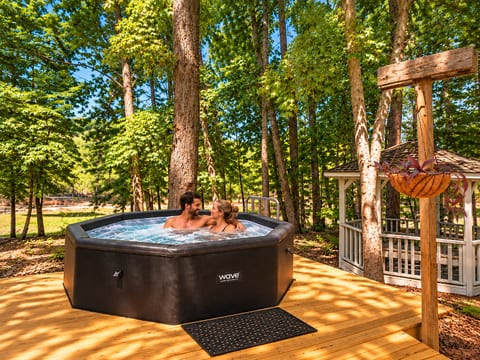 Soak and unwind. Your private hot tub is tucked beneath the trees, creating the perfect spot to relax together after a day on the lake or exploring Clemson.