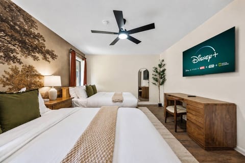 Space to settle in and stay awhile ✨ Two queen beds, a dedicated workspace, and a TV for winding down.