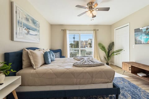 Bright coastal bedroom with balcony view