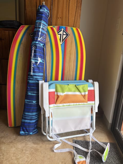 Beach gear included: boogie boards, umbrella, and portable beach chairs