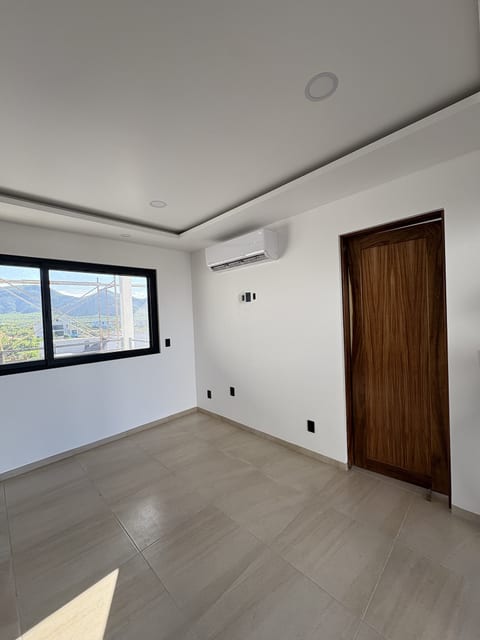 Bright modern room with AC, large window, and sleek tile floors