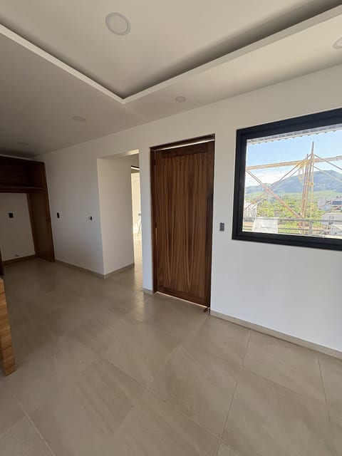 Bright modern interior with natural light, sleek tile floors, and warm wood accents