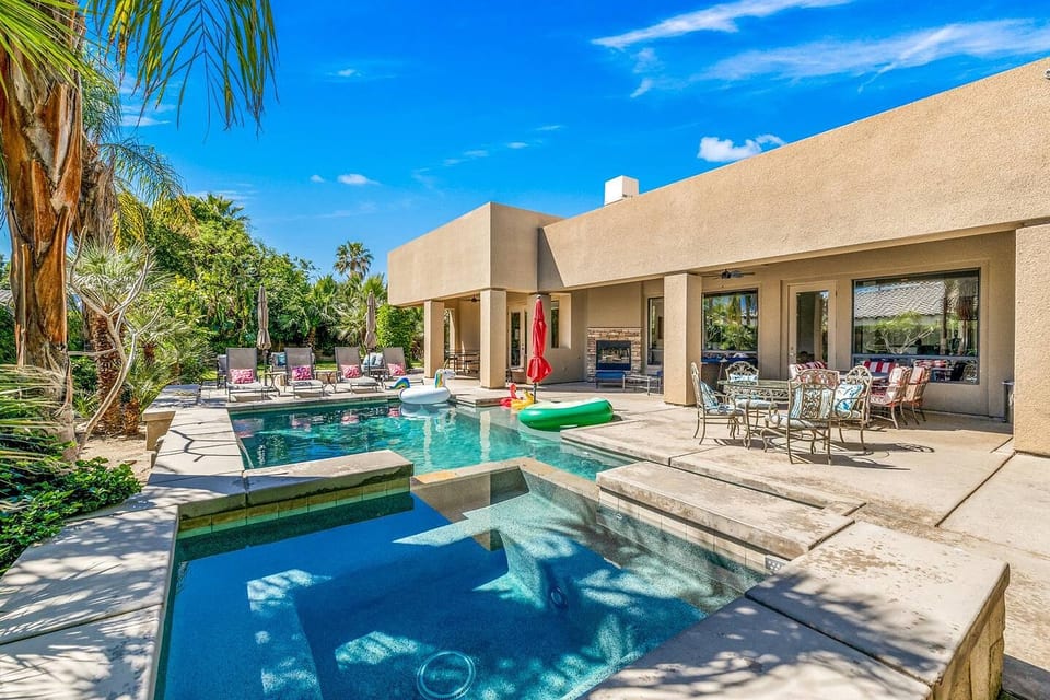 Backyard: Pool and Spa with Sheet Water Fall feature, Covered Patio Sectional Sofa, Two Dining Tables, Outdoor Fire Place, Pool Loungers and BBQ with Bar.