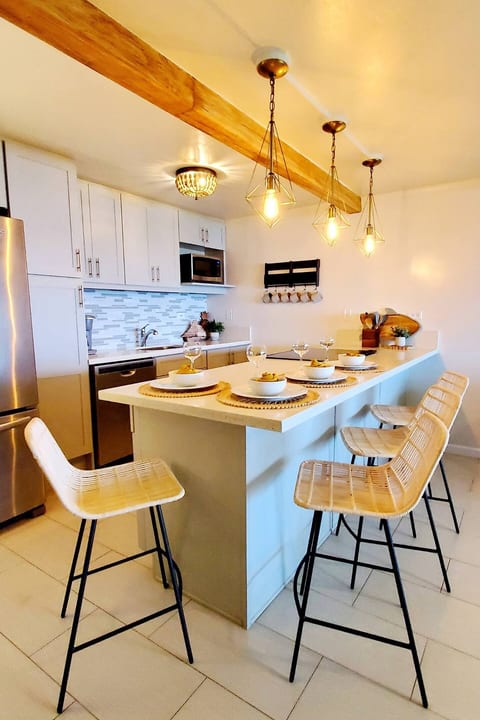 Kitchen & Dining Bar Counter w/ seating for 4. Kitchen Stainless steel appliances include refrigerator, dishwasher, microwave, stove/range, coffee maker and toaster.