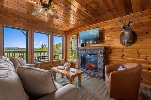 Cozy living room with electric fireplace and mountain views
