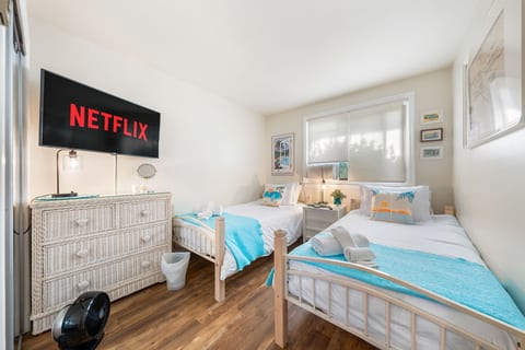 Kick back after a beach day—this twin room is cozy, fun, and Netflix-ready for a seaside movie night.