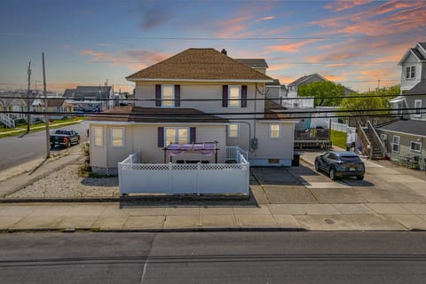 Evenings glow softly at your beach retreat—gather under the pergola or unwind as the sun sets over Wildwood.