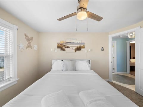 Soft coastal décor and morning light make this bedroom the perfect place to start your day by the sea.