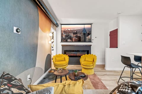 You'll love this view! Relax on the comfy couch and enjoy the projector, fireplace, and the whole stylish space.