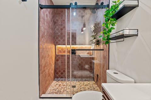 Refresh in this luxurious, spa-inspired shower featuring sleek tiles, adjustable shower heads, and a relaxing ambiance.
