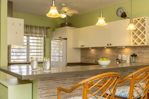 Seating at countertop for drinks or snacks or meals.  Warm, ambient lighting.