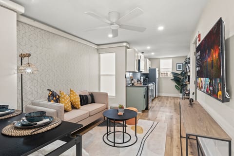 Open-concept living with designer touches, smart TV, and cozy textures—perfect for relaxing nights in.