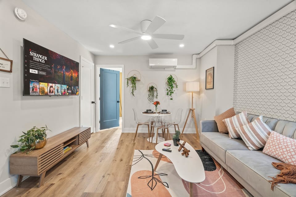 Modern comfort meets city charm in this bright living space with streaming TV and warm design details.