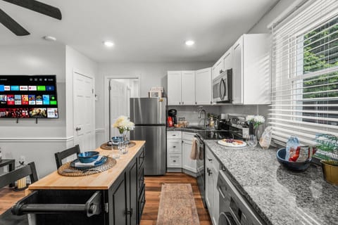 Appreciate the convenience and charm of this open kitchen layout. The sleek appliances and thoughtful design create an inviting space where you can cook, dine, and relax in comfort.