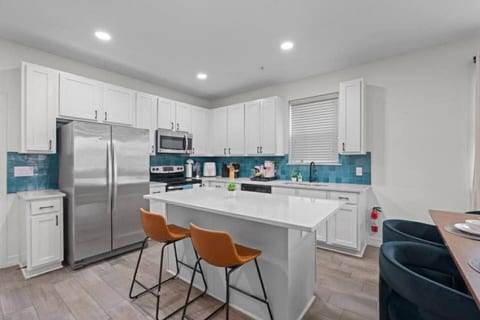 Chat with somone cooking while hanging out in this full kitchen. Room for two to sit.