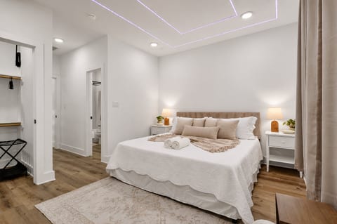 Serene king suite with LED ceiling, ensuite, and open closet