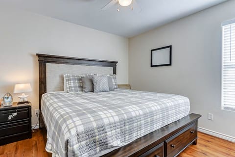 Bright, cozy bedroom with a spacious bed and warm wood finishes