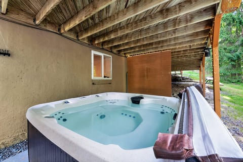 Private covered hot tub with rustic charm and peaceful wooded views