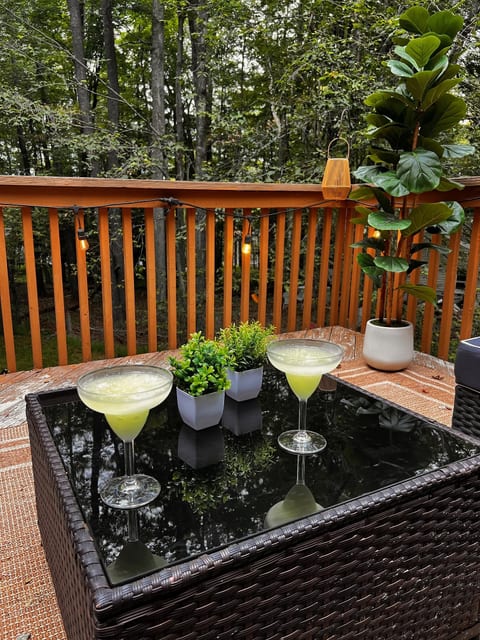 Private forest-view deck with cozy lighting and stylish outdoor dining