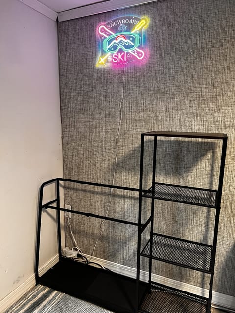 Industrial wall shelving with fun neon ski-lodge style accent