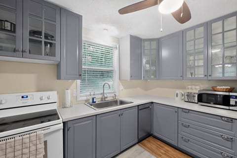 Bright modern kitchen with gray cabinets and sunny window