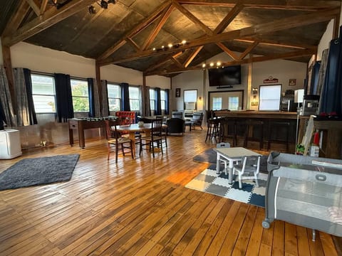Spacious loft-style game room with bar, foosball, and family-friendly seating
