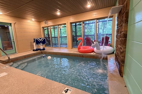 Private indoor pool with forest views, water feature, and fun family extras