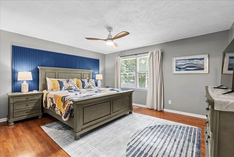 Close the door and rest. Dark wood bed, floral quilt.