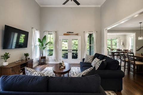 Bright, open living room with vaulted ceilings, comfortable seating, Smart TV and easy flow into the dining and kitchen areas, with direct access to the screened patio.