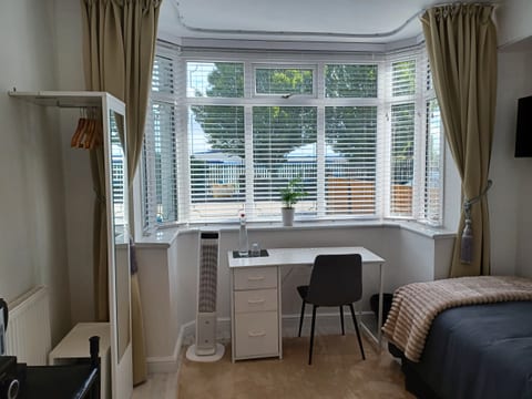 Your light-filled private room with bay window, desk and smart TV. Built-in USB-A and USB-C charging ports on your bedside table.