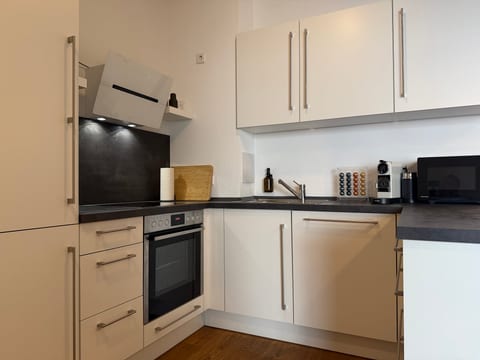 Modern, fully equipped kitchenette with coffee machine and sleek finishes