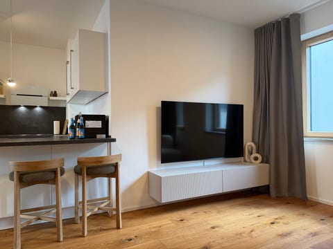 Bright modern living space with breakfast bar and sleek TV lounge