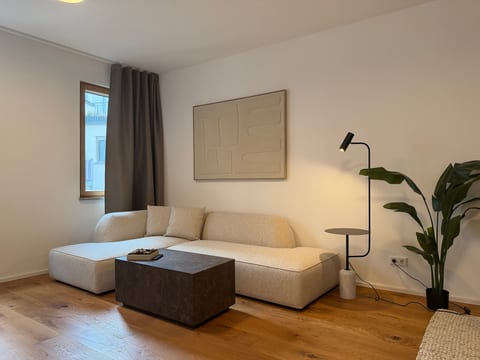 Modern minimalist living room with cozy sectional and warm ambiance