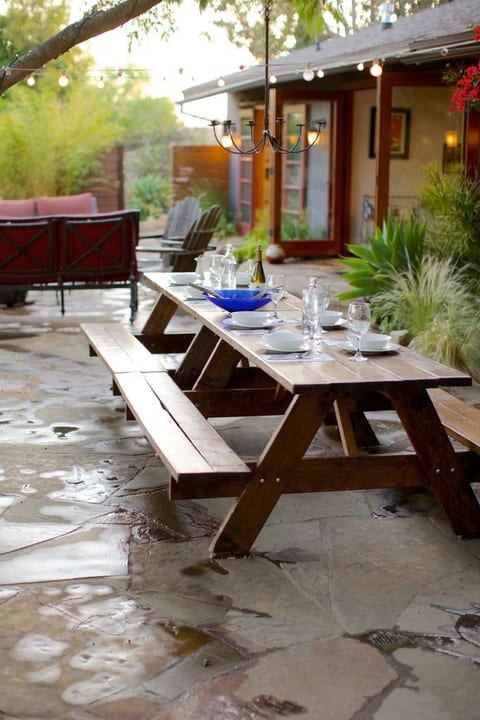 12' long outdoor dining table with overhead twinkly lights