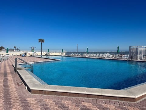 The deep end of the pool, and the beach access gate is in the mid right section of the picture