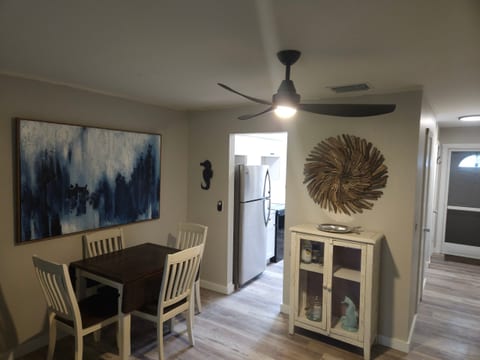 Dining area leading to kitchen & front door