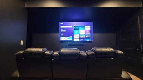 Enjoy the surround sound in the theater room including reclining theater seating, popcorn machine and blankets to enjoy movies on the 75" Roku TV.