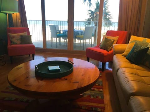 Living room with a view of the balcony and Ocean while sitting on the couch.