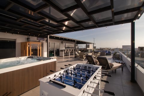 Spacious rooftop terrace with ocean views, outdoor kitchen, dining & lounge areas