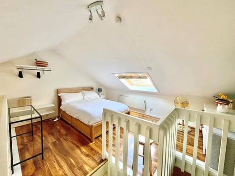 Double bed with fresh 100% cotton linens, 2 sets of pillows, a slim glass table, stool, adjustable gold fan, bedside light, electric blankets (October - March only) black out blinds.