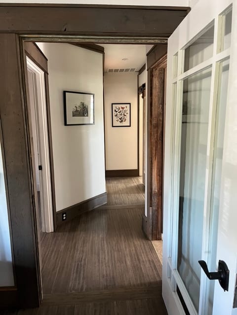 Hallway leading from the living room to the kitchen, bedrooms, and bathroom.