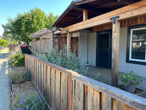 Front of house includes California native plants, a covered front porch, security door, and secure mailbox.