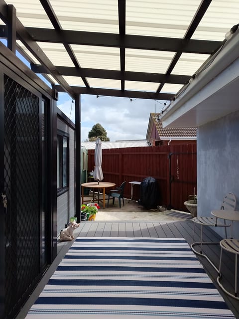 Enjoy a secluded coffee on the private deck with Jack & Jill seating. Step into the yard to relax at the outdoor table with umbrella.